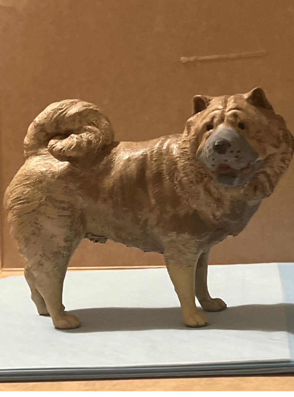 Custom hand-painted pet sculpture of a dog next to the real dog